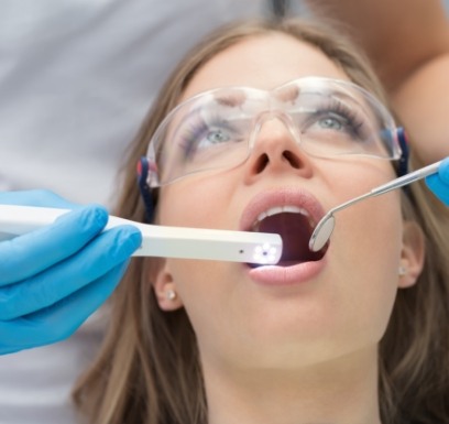 Dentist using intraoral camera to capture smile images