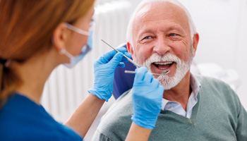 Man smiles at dentist