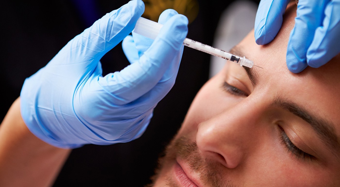 a man getting BOTOX in his forehead