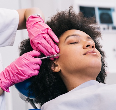 a woman receiving a BOTOX injection