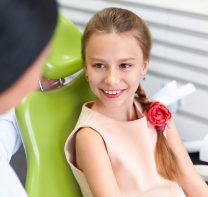Child smiling during dental checkup and teeth cleaning for kids visit