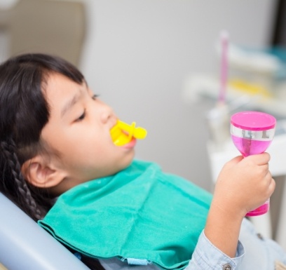 Child receiving fluoride treatment