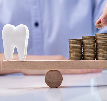 Tooth balanced with a pile of coins