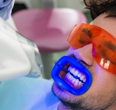 Dental patient receiving teeth whitening treatment