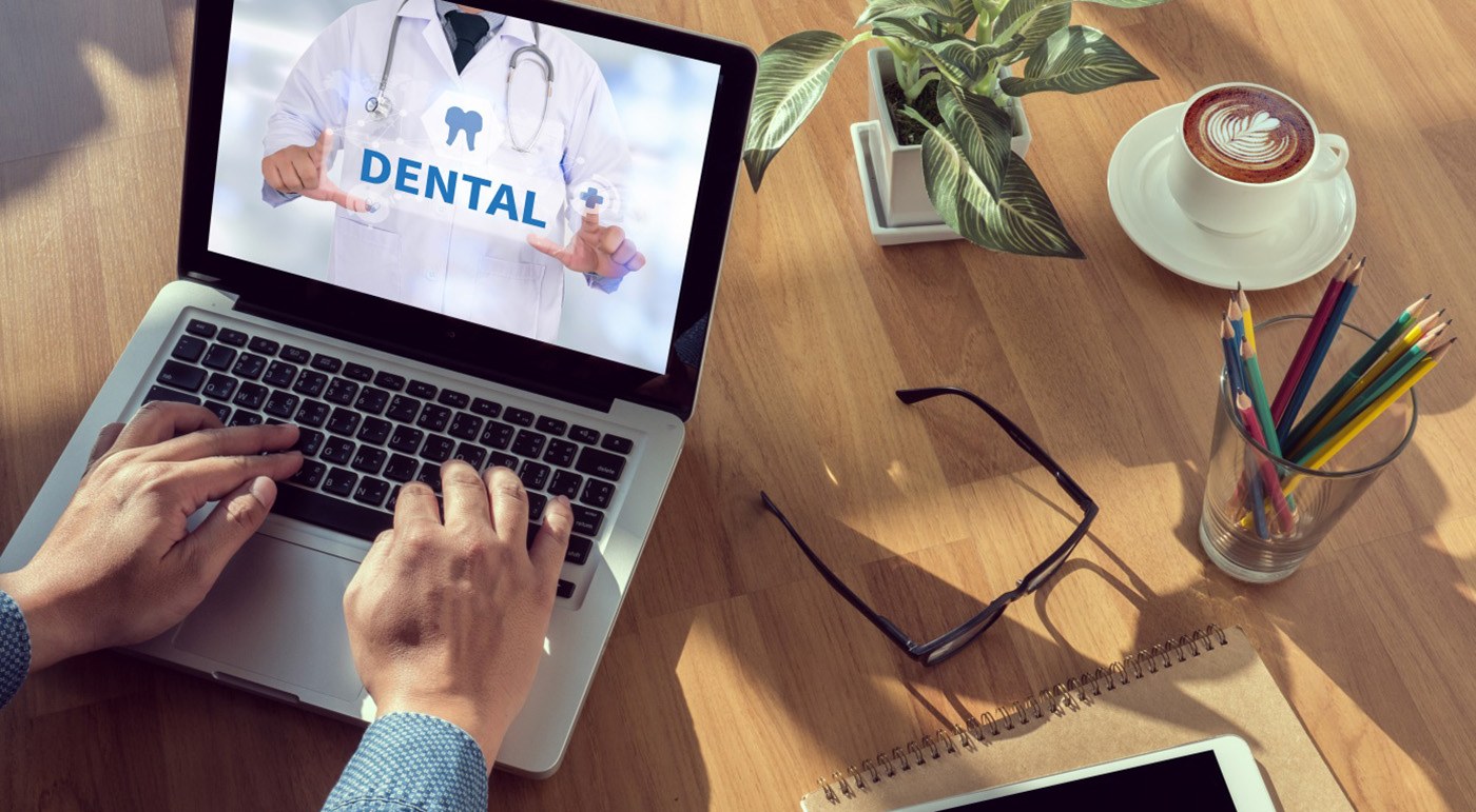 Person using computer to learn about dental benefits