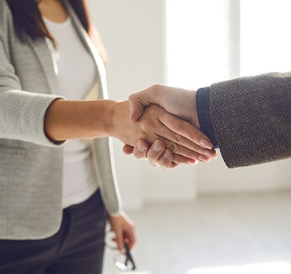 Man and woman shaking hands in professional environment
