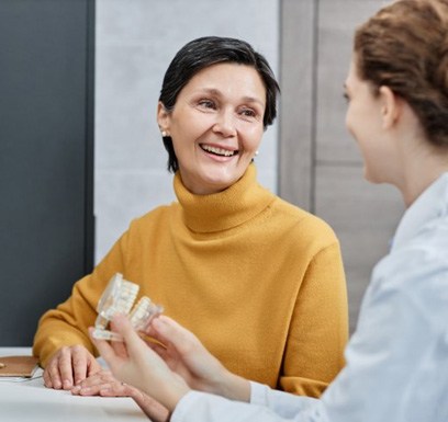 a patient talking to her dentist about dental implants
