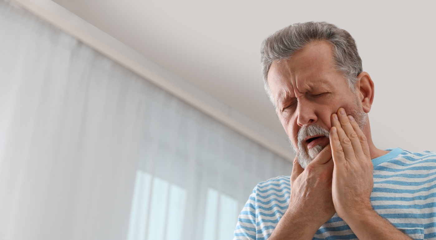 Man in pain before emergency dentistry