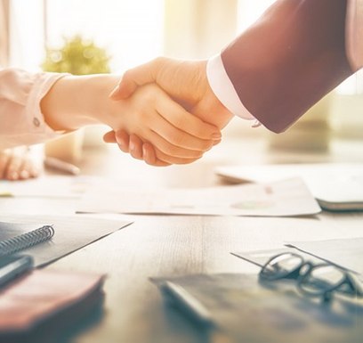 two people shaking hands after meeting