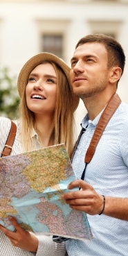 Young man and woman carrying a map