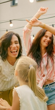 Group of young women laughing while dancing