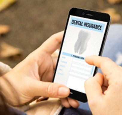 Woman looking at dental insurance form on phone