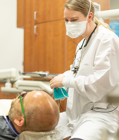 Doctor Flinchum talking to dental patient