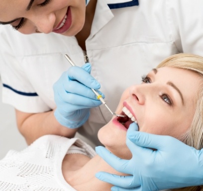 Dentist examining dental patient's smile after antibiotic therapy