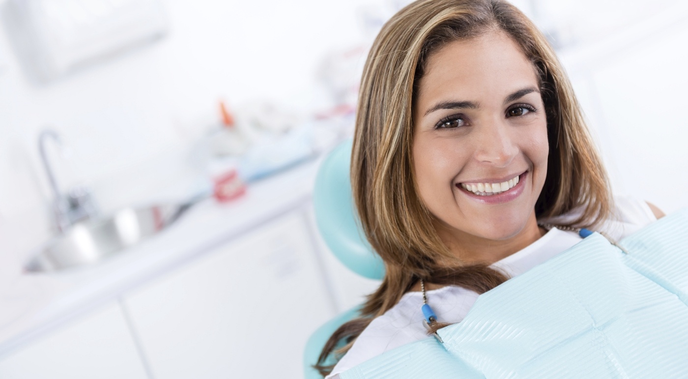 Woman sharing healthy smile after preventive dentistry