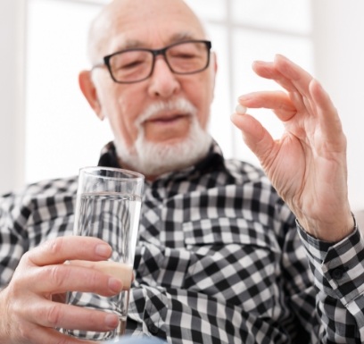 Man taking an oral conscious dental sedation pill