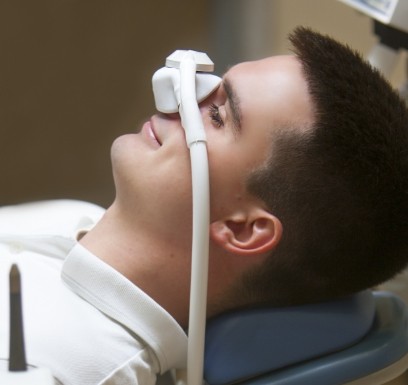 Dentistry patient with nitrous oxide dental sedation nose mask in place