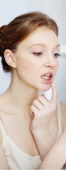 Woman looking at smile before replacing missing teeth