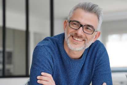 man smiling with arms crossed