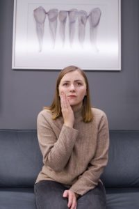 Woman in the waiting room at an emergency dentist