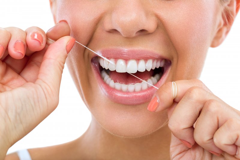 Lady flosses teeth
